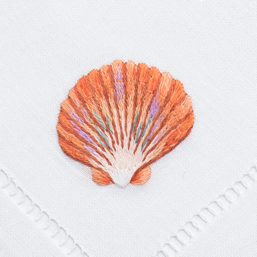 an embroidered scallop shell in the blush color