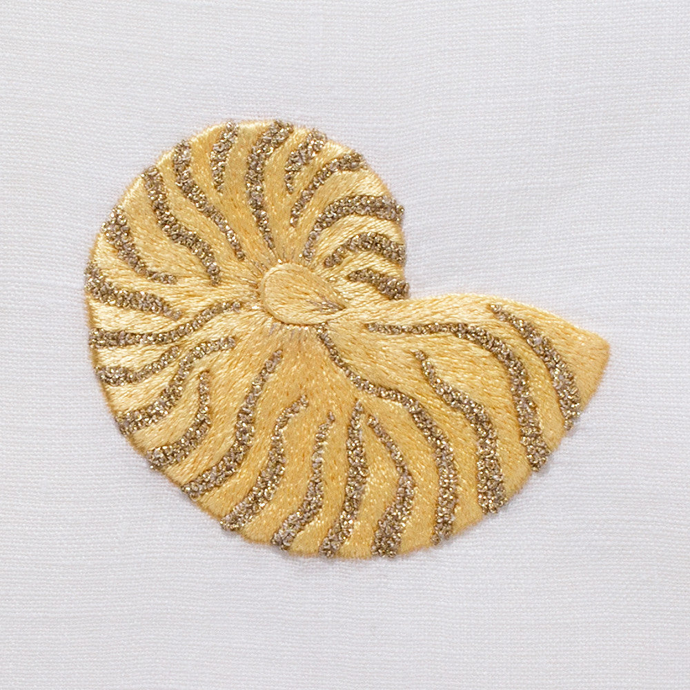 A detailed image of the embroidery - A gold nautilus shell