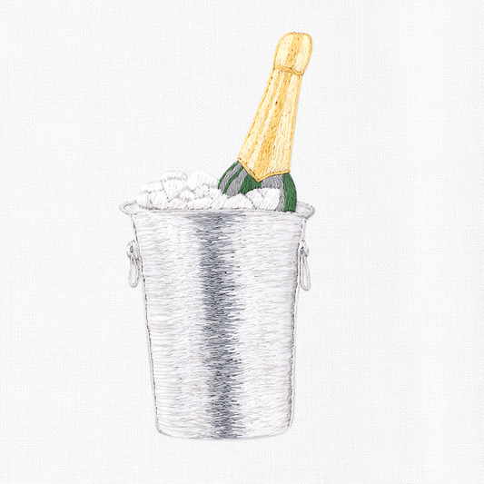 A close up detailed image of the embroidery - A green, gold-capped champagne bottle in a silver ice bucket.