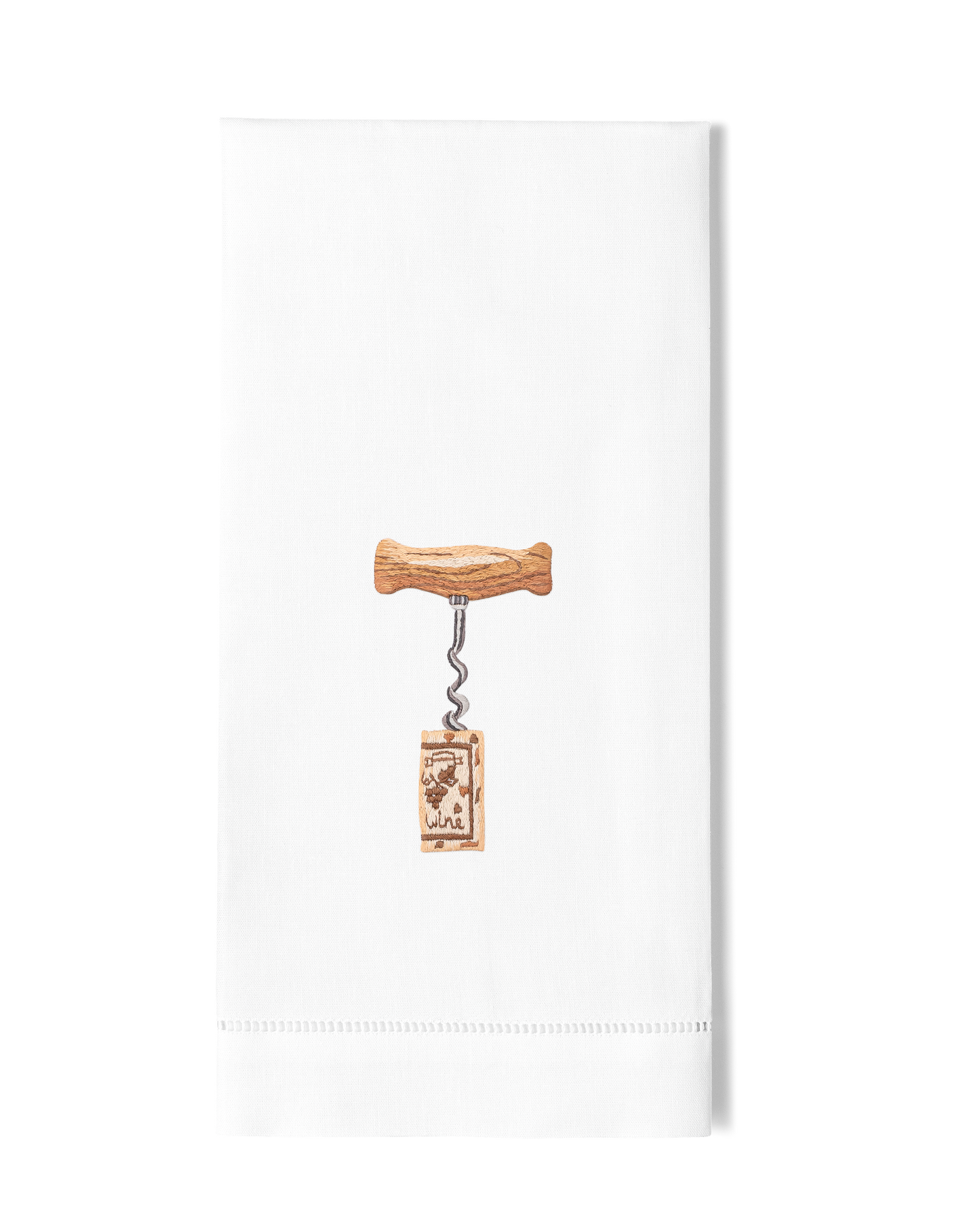 A white hand towel with a hemstitch. A wooden corkscrew twisted into a cork is embroidered in the center.