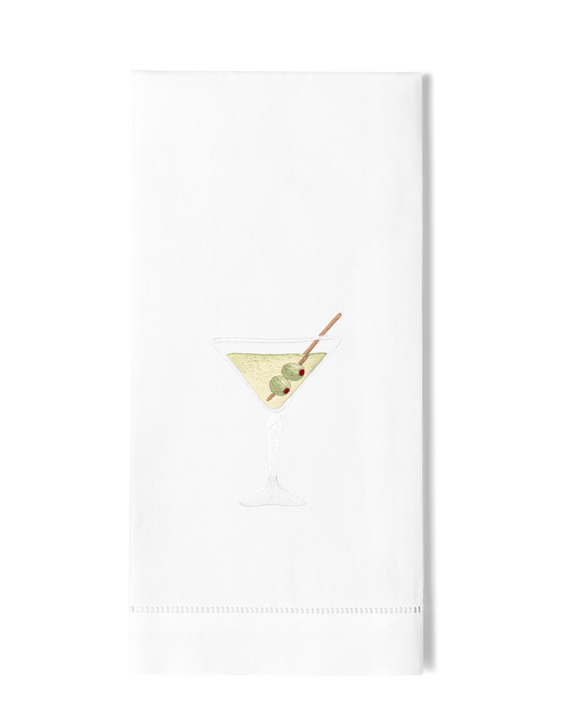 A white hand towel with a hemstitch. A dirty martini is embroidered in the center.
